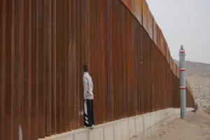 man standing on fence