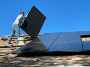 man installing solar panels