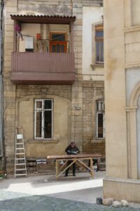 street carpenter working in historical building courtyard